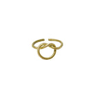 A gold ring, with a center pretzel design, is shown against a stark white background.