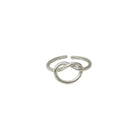 A silver ring, with a center pretzel design, is shown against a stark white background.