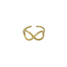 A gold ring with center infinity sign motifs is seen against a stark white background.