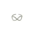 A silver ring with center infinity sign motifs is seen against a stark white background.