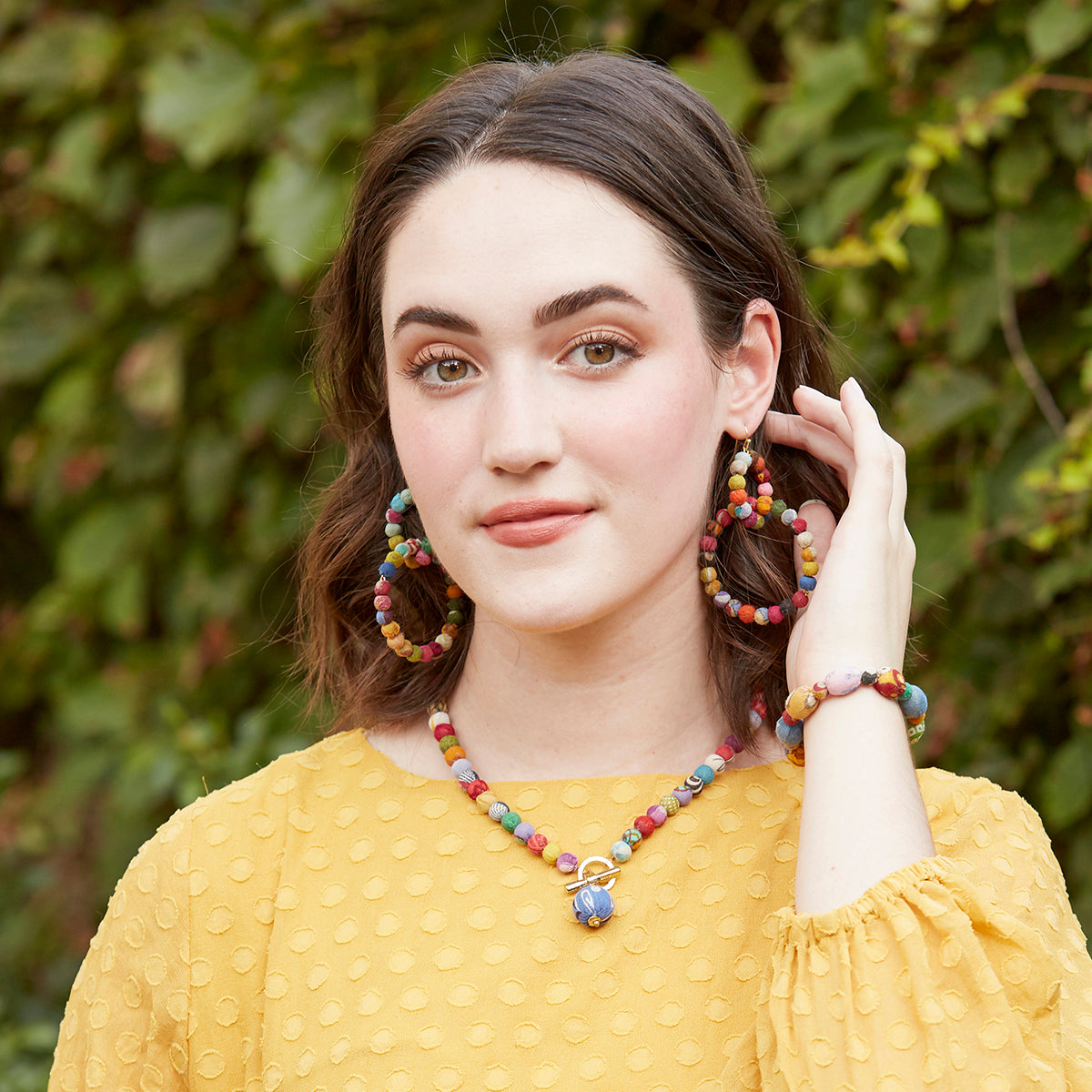 Model with red hair, brown eyes and freckles, poses, beauty shoot. She  wears gold rectangle earrings, looks down, natural make up. Stock Photo |  Adobe Stock