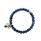 A blue beaded bracelet against a white background.