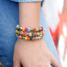 A close up of a woman's wrist and the three bracelets she is wearing.