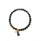 A black beaded bracelet against a white background.