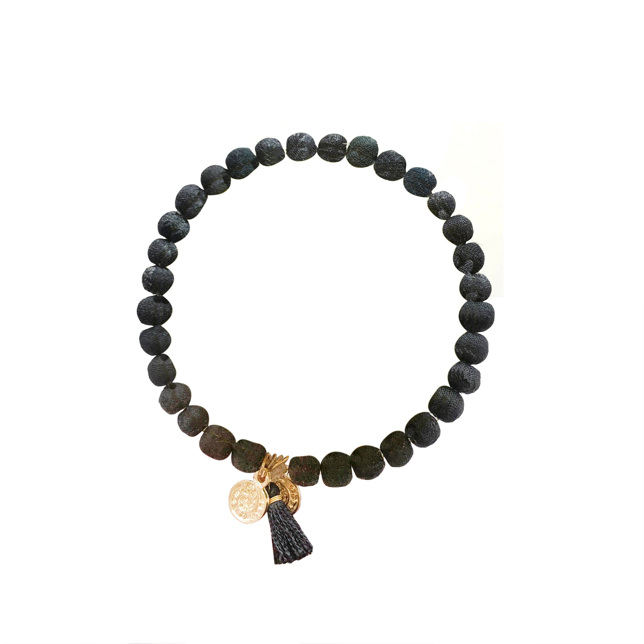 A black beaded bracelet against a white background.